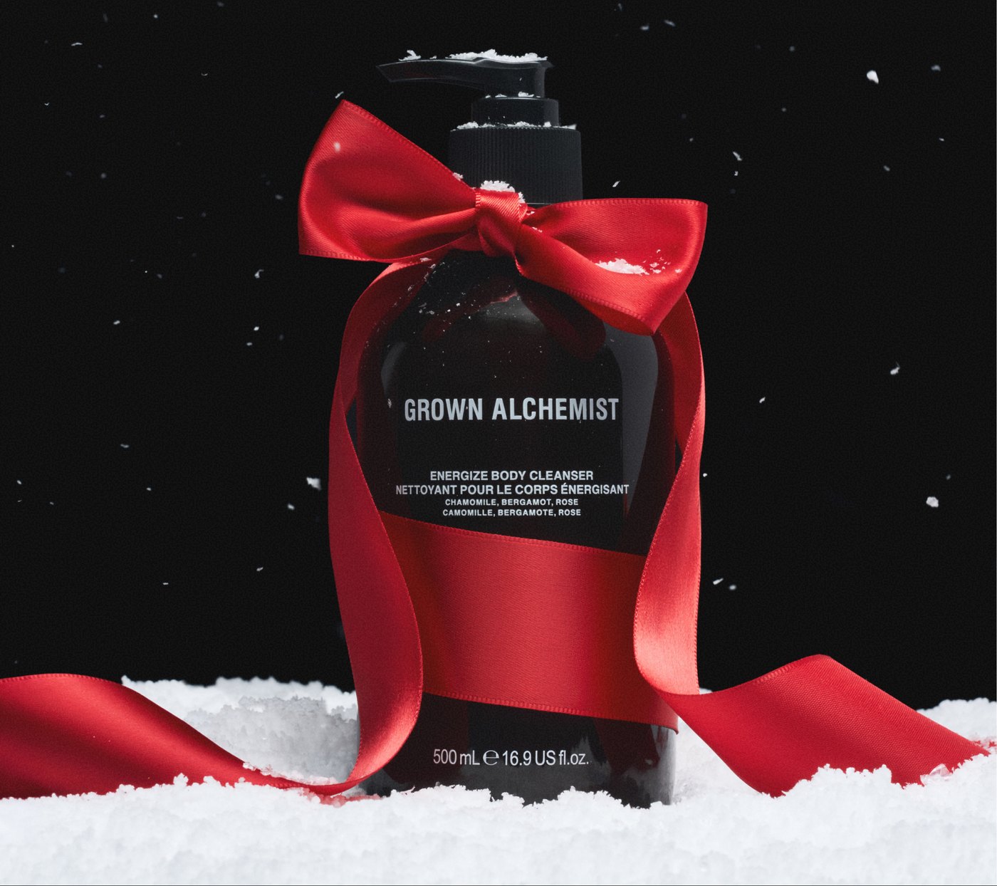 Body cleanser tied with a red ribbon in falling snow