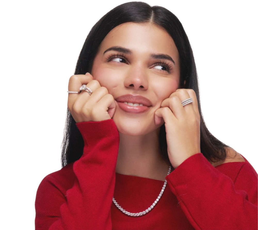 Model in a red jumper wearing diamond rings and a tennis necklace