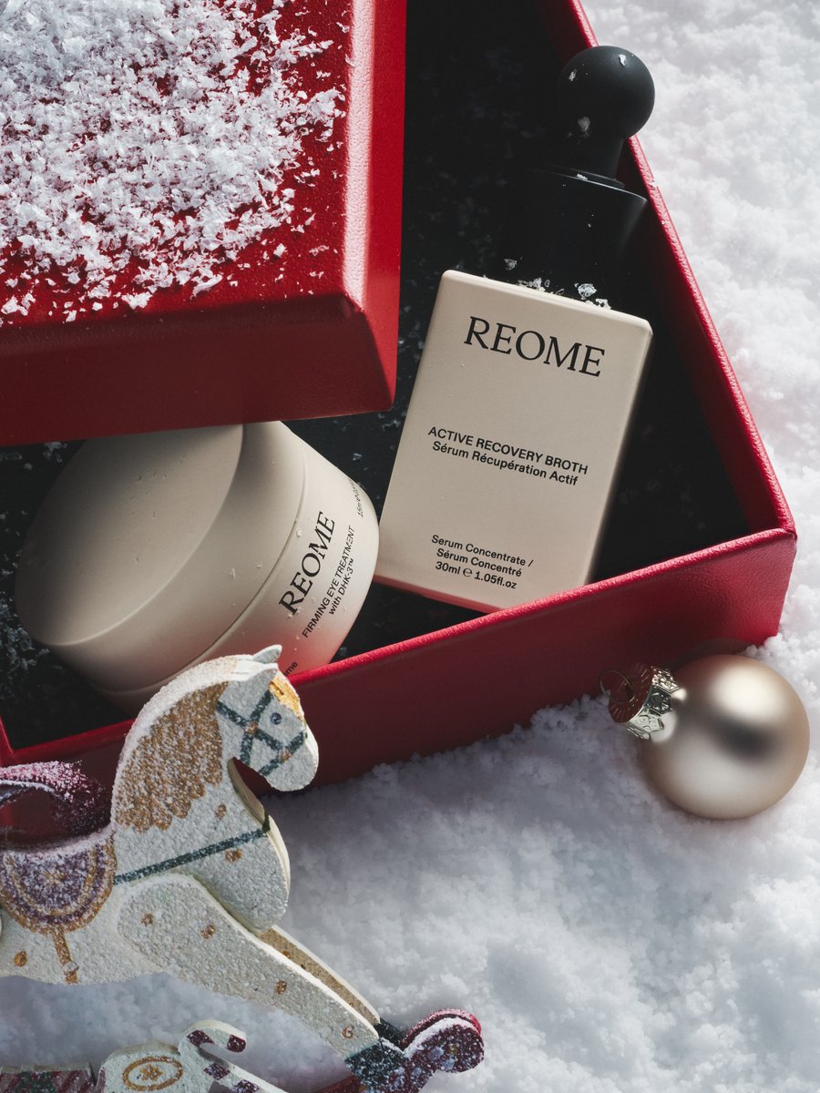 REOME skincare in an open red gift box with a wooden rocking horse