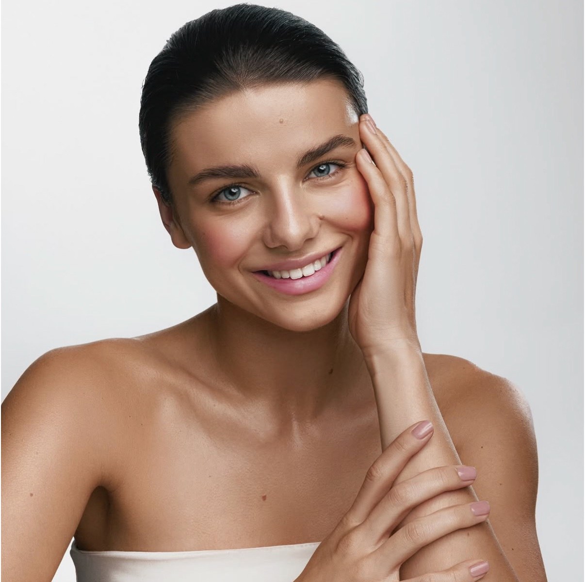 Smiling beauty portrait in a white strapless top, shot by a previous workshop participant