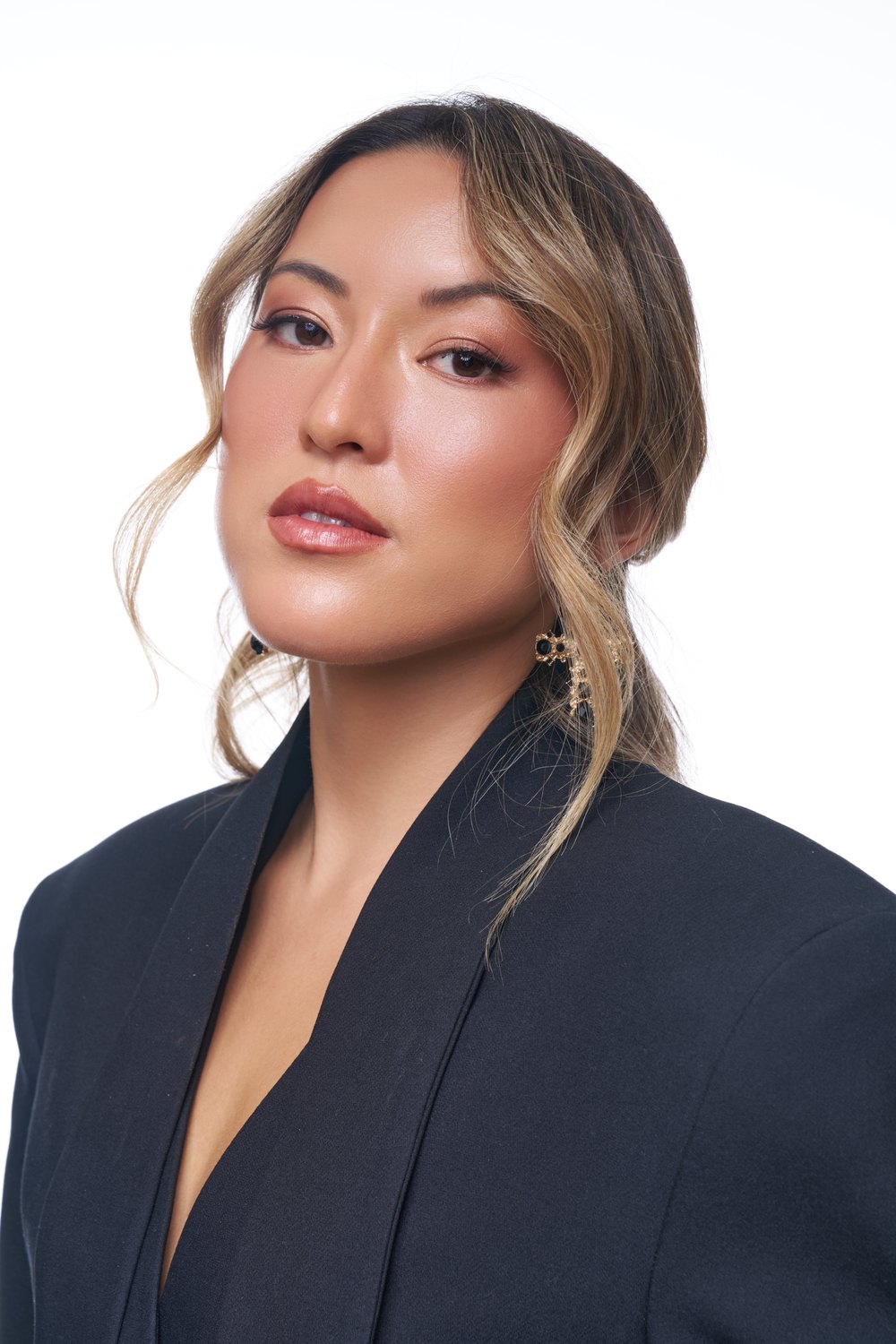 Beauty portrait in a black blazer with gold earrings, shot by a previous workshop participant