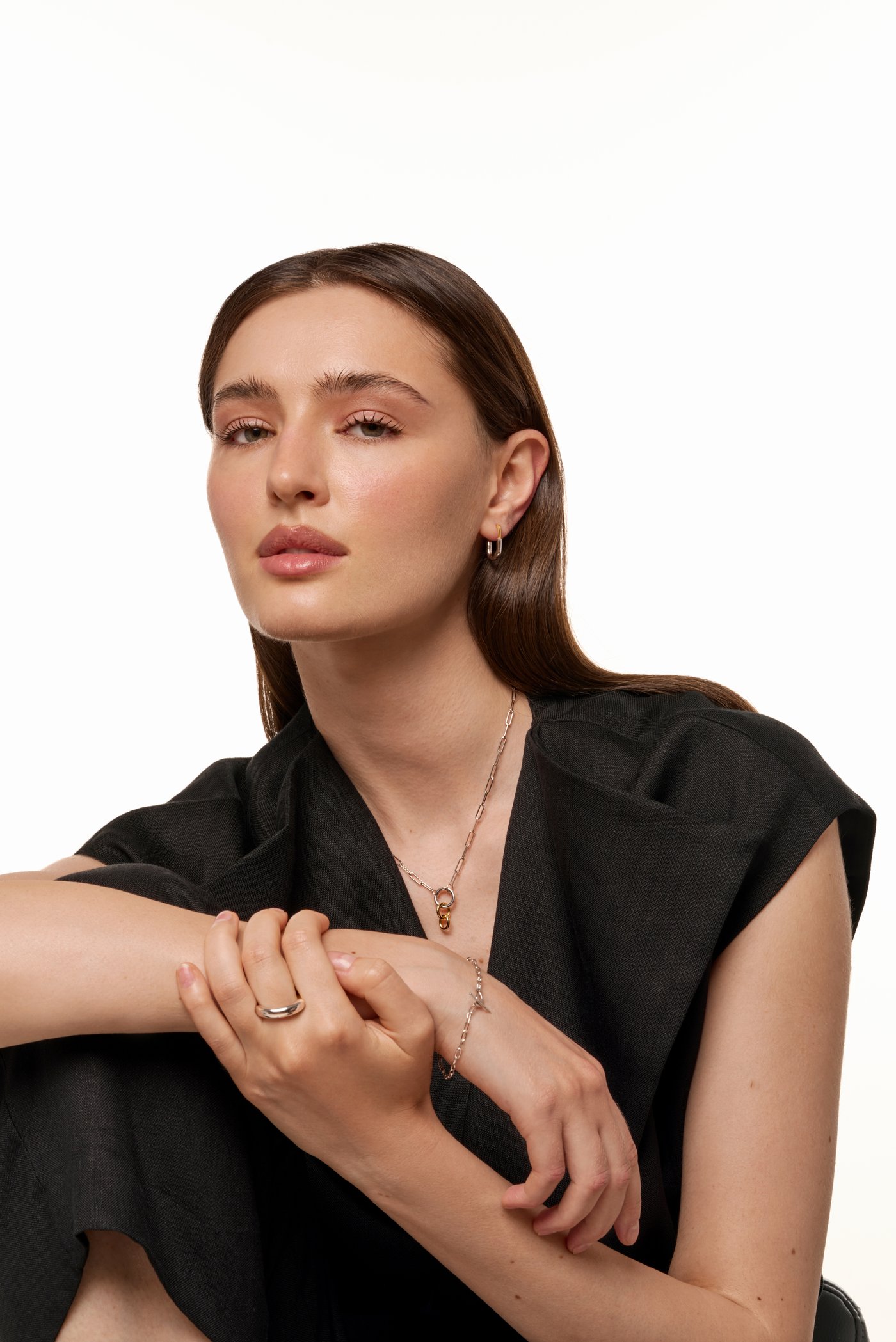 Beauty portrait with delicate gold jewellery on a white background